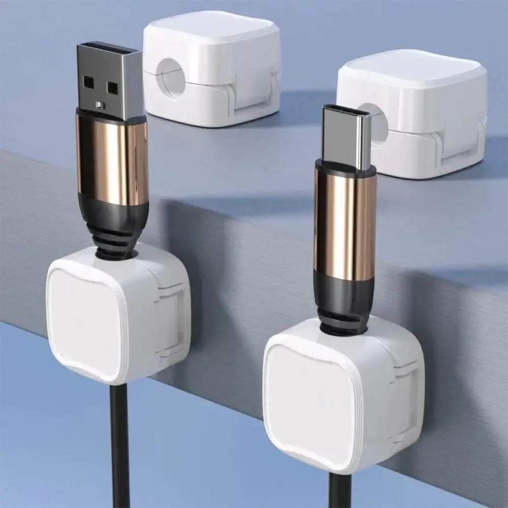 White magnetic square under desk cable organizers holding gold and black usb connectors for cord management