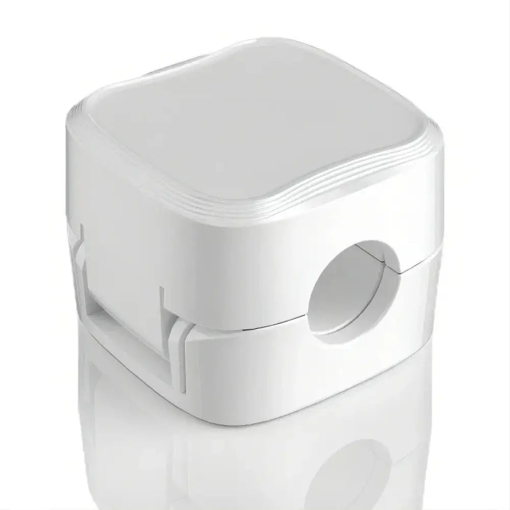 White plastic magnetic square under desk cable organizer with circular cutout and ridged edges for cord management