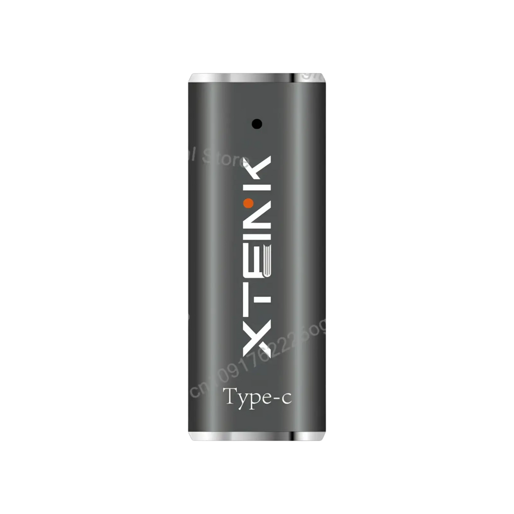 A sleek matte black x-tek type-c usb flash drive with silver ends shown with the official original magnetic charging dock