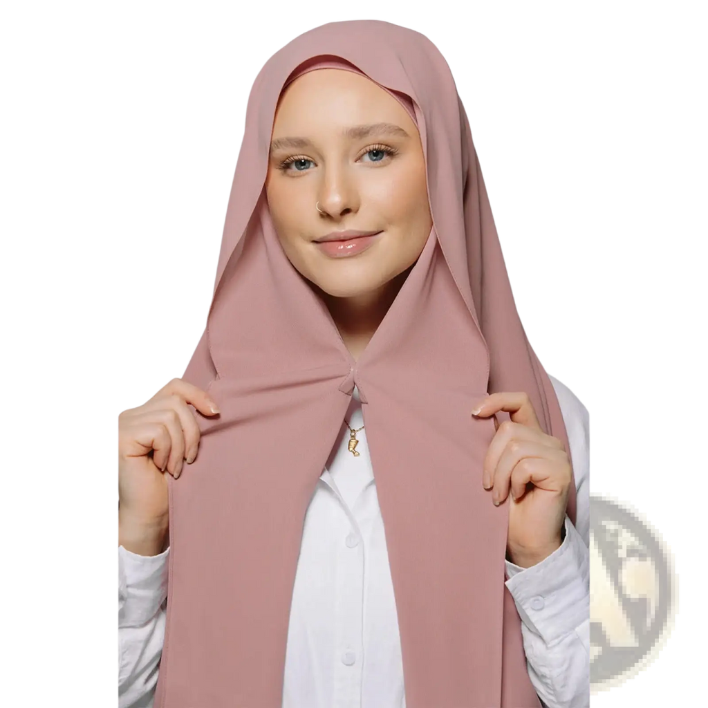 A soft blush pink magnetic chiffon hijab with smooth flowing fabric draped elegantly over the head and shoulders