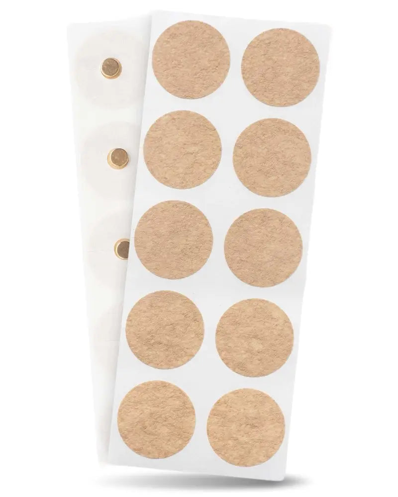A sheet of light brown cork adhesive neodymium magnetic therapy patches arranged in a grid on white paper