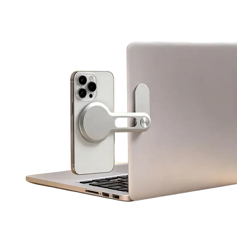Silver aluminum magnetic phone holder securely holding a white iphone on the back of a laptop