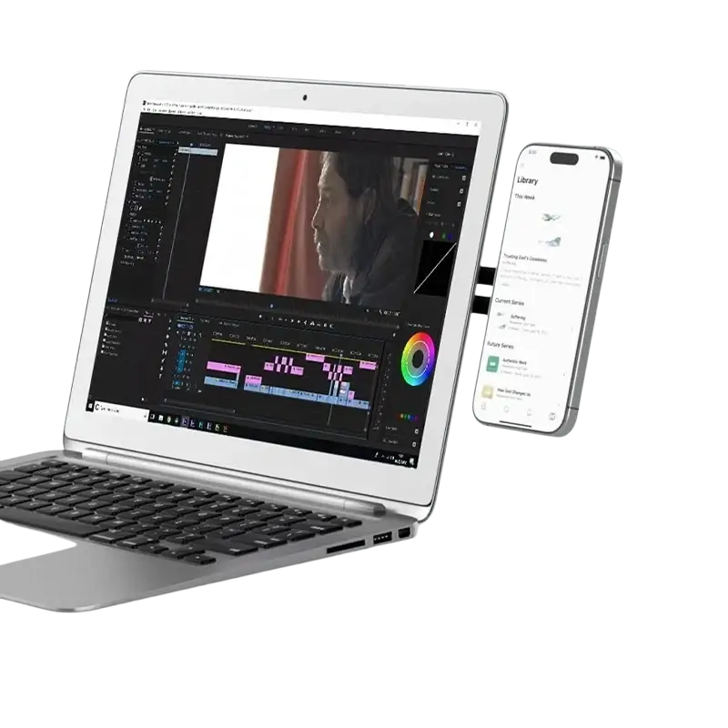Silver aluminum magnetic phone holder laptop stand attached to a laptop with video editing software on screen