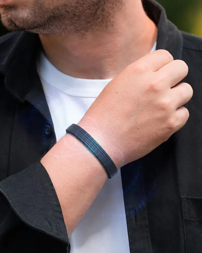 Black textured magnetic silicone sports bracelet worn on a man’s arm by Magnetrx classic collection