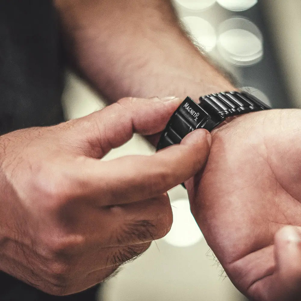 Black magnetic therapy stainless steel watch band with sleek ridged design and magnetr brand name on clasp