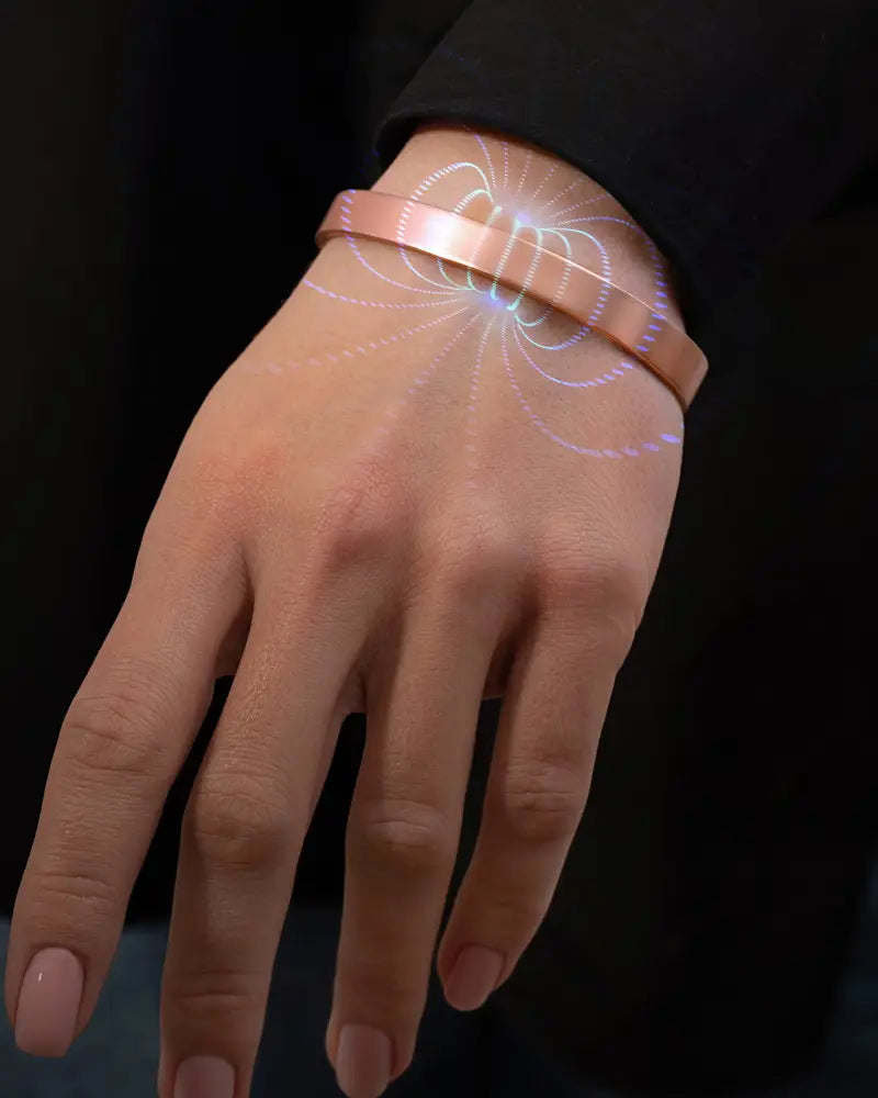 A sleek rose gold pure copper magnetic therapy cuff bracelet with minimalist design and subtle glowing lines