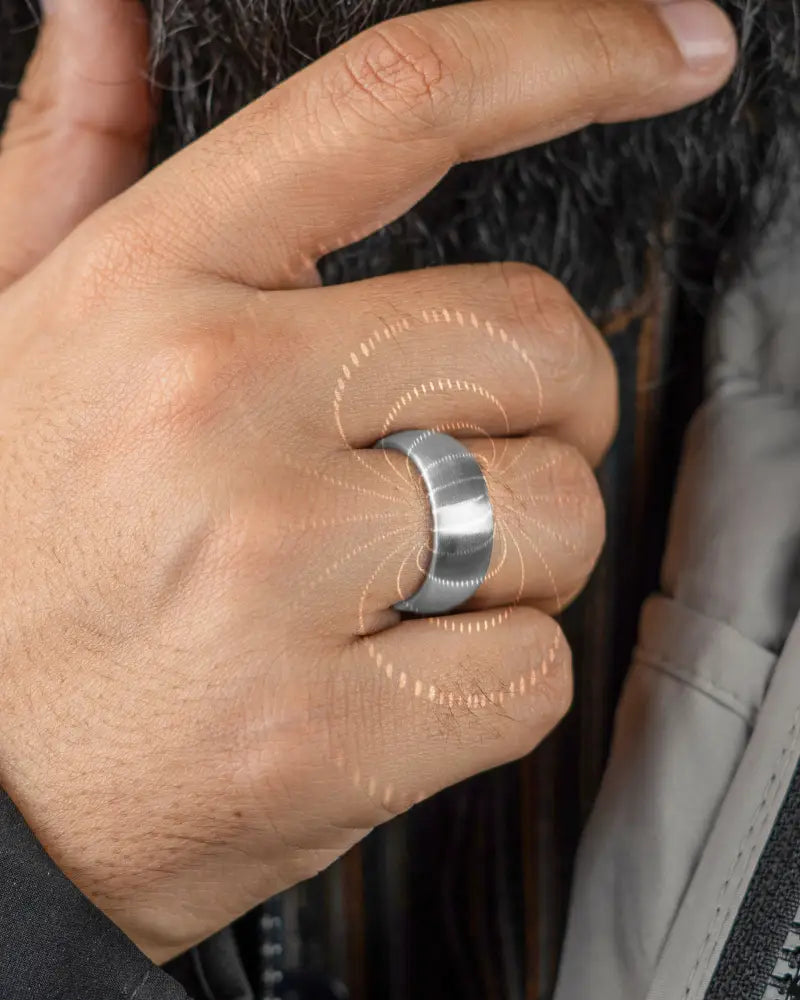 A sleek silver-toned brushed silver magnetic therapy ring with neodymium magnets and a modern minimalist design