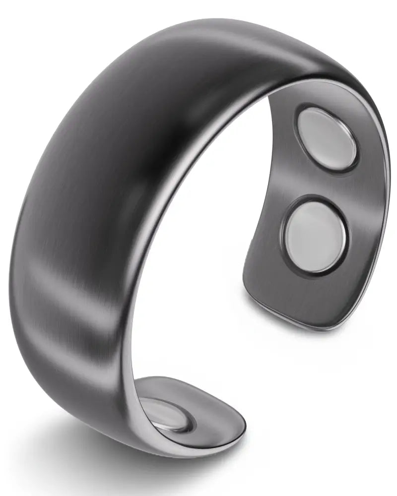A sleek gunmetal matte magnetic neodymium therapy cuff bracelet with silver-toned magnets on its inner surface
