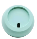 A matte mint-green circular silicone lid with a small black rectangular slot for a magsafe wireless charging desk stand