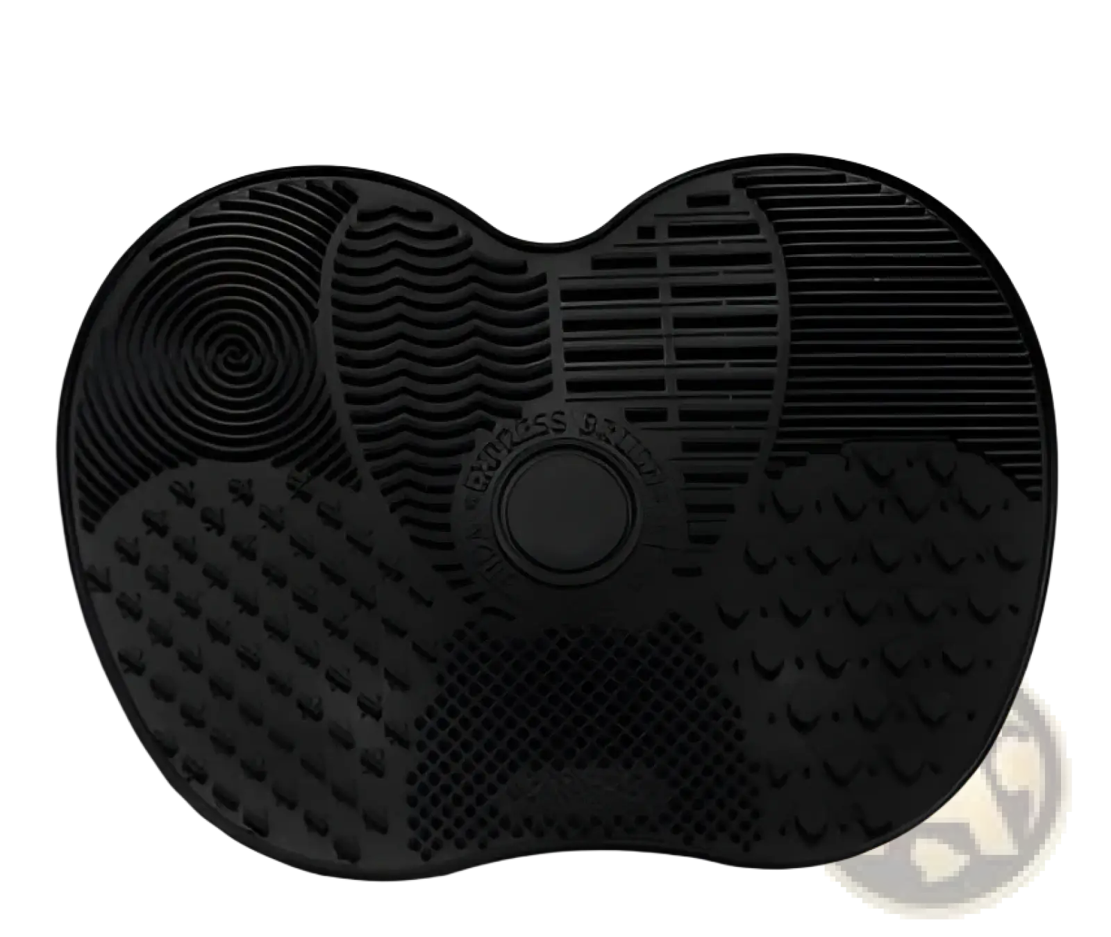Black silicone heart shaped grooming mat with textured surfaces and central circular button for makeup brush cleaning