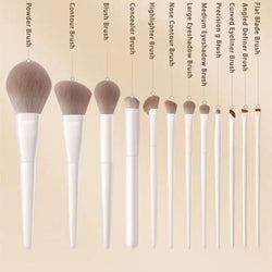Makeup brush set with ten white handles and soft tapered bristles for diverse cosmetic applications