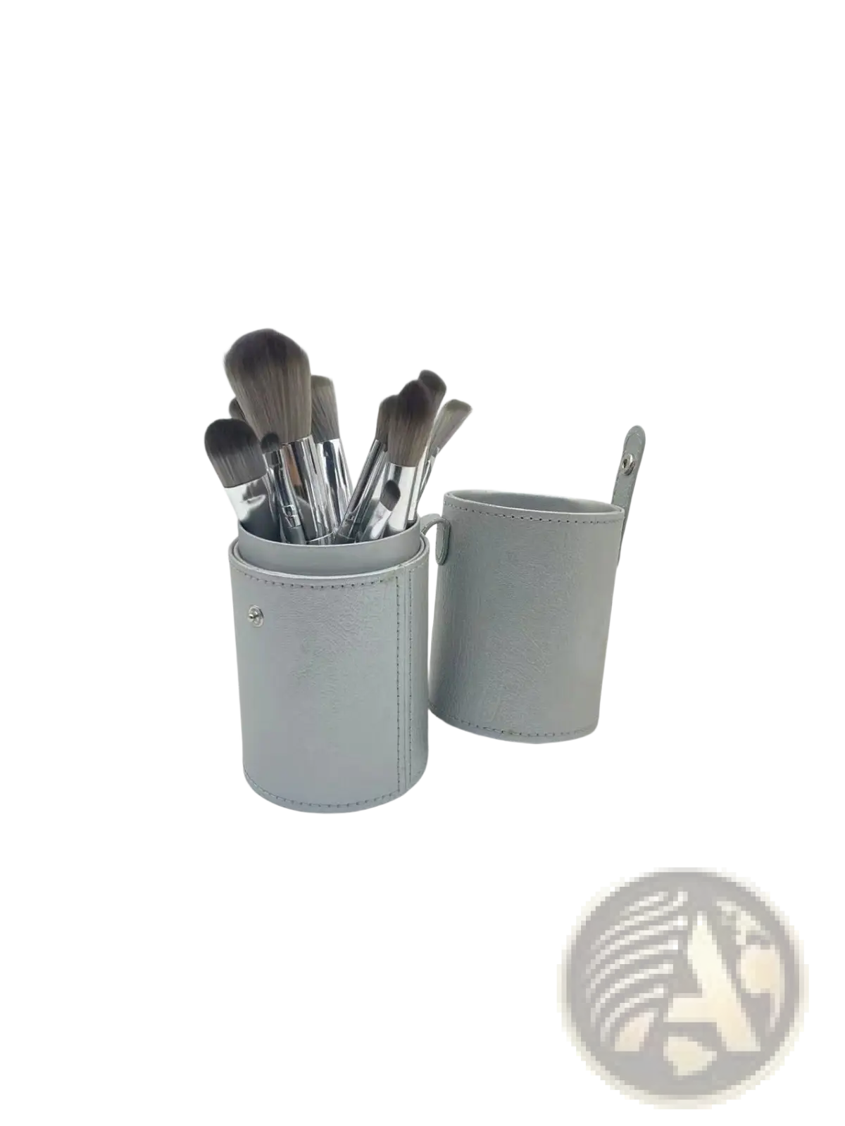 Gray leather makeup brush case with silver hardware and handle holding 15 silver makeup brushes of varying sizes
