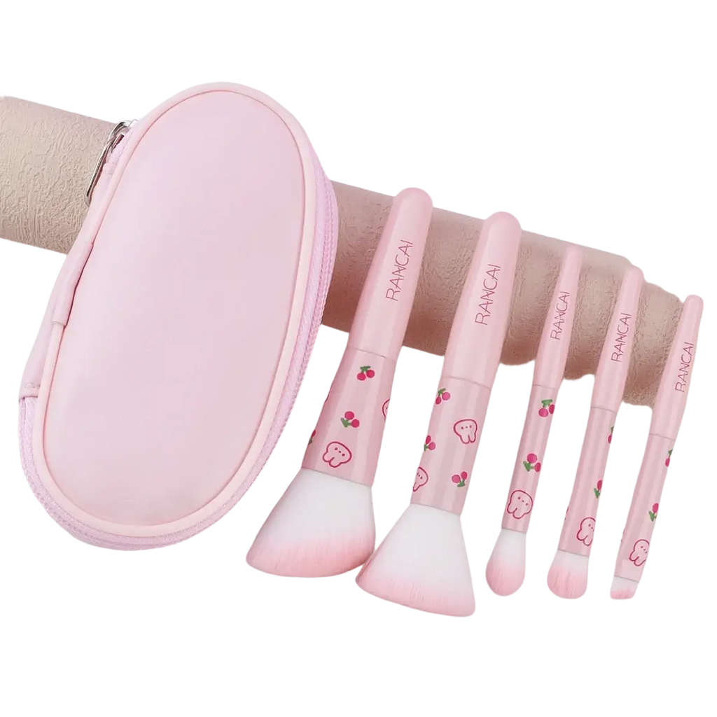 Pink rancai makeup brush set with soft white bristles and cherry ghost designs on handles in a cute pink 5 piece case