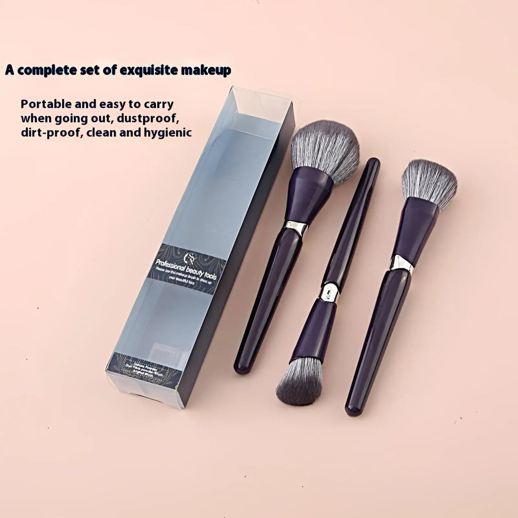 Makeup brush set with soft grayish-bronze bristles, purple handles, silver accents in a transparent box for face powder