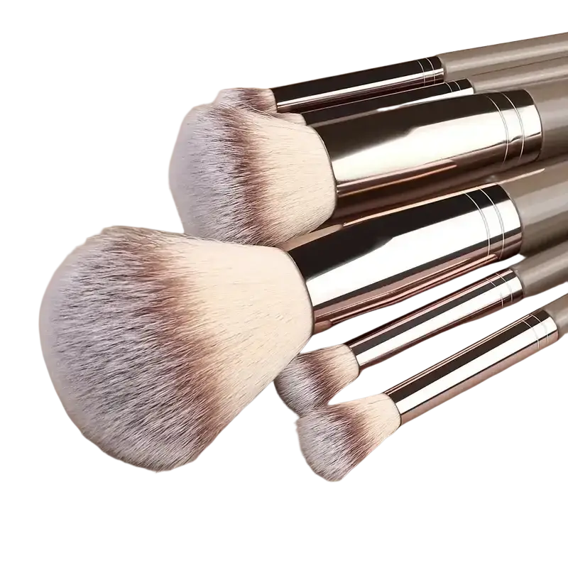 Set of five makeup brushes with soft synthetic bristles and metallic rose gold handles for professional beauty use