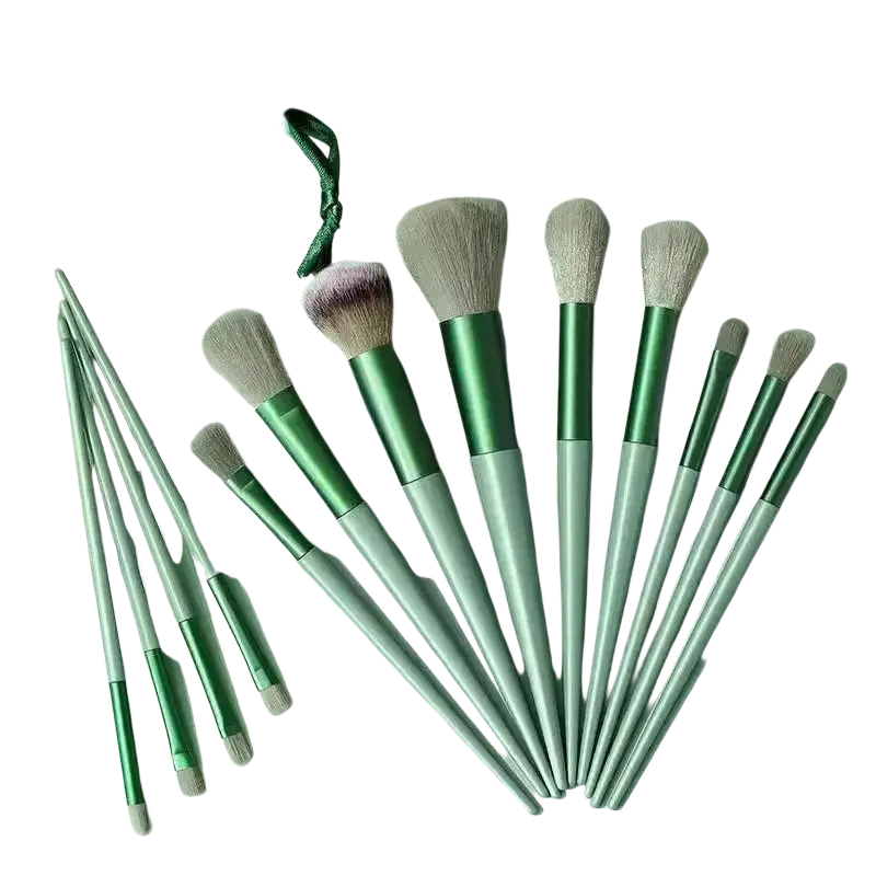 Set of 12 makeup brushes with synthetic fiber bristles and silver emerald handles with storage pouch for precise application