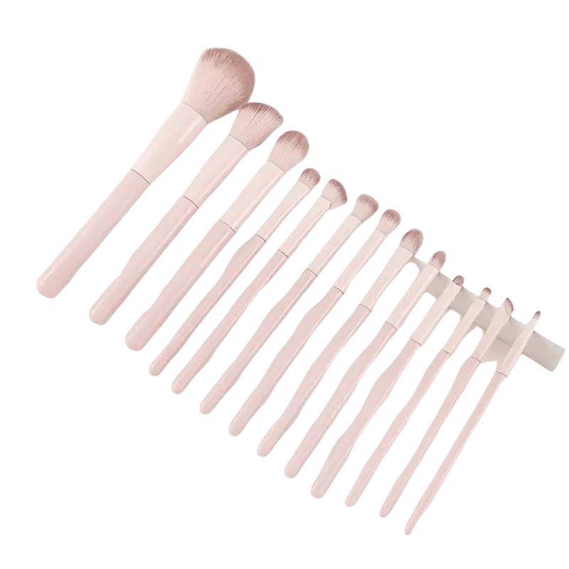 Set of blush pink wool fiber makeup brushes with soft fluffy bristles and sleek handles in beginner kit