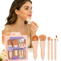 A complete set of five blush and powder makeup brushes with soft peach ergonomic handles made in mainland china
