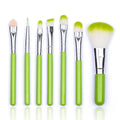 Set of seven professional synthetic foundation and face brushes with green handles silver ferrules and gradient bristles