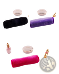 A plush cylindrical reusable microfiber makeup remover towel in black purple and pink from a 5 pack set
