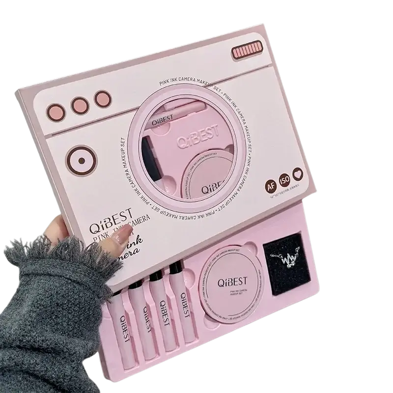 Pink qibest camera shaped makeup set with pastel pink faux plastic finish and compartments for brushes and compact powder