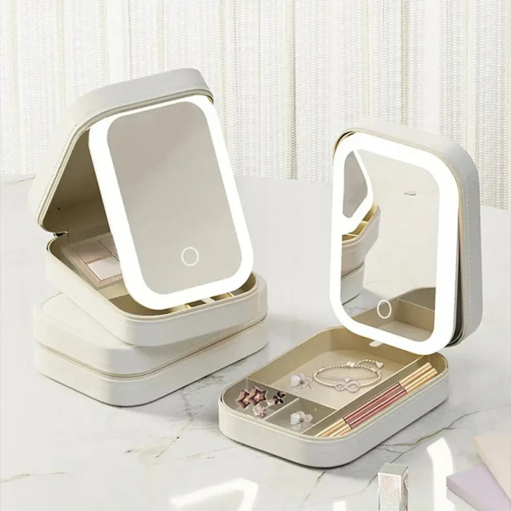 Beige rectangular led mirror jewelry box with illuminated edges and organized compartments for travel makeup storage