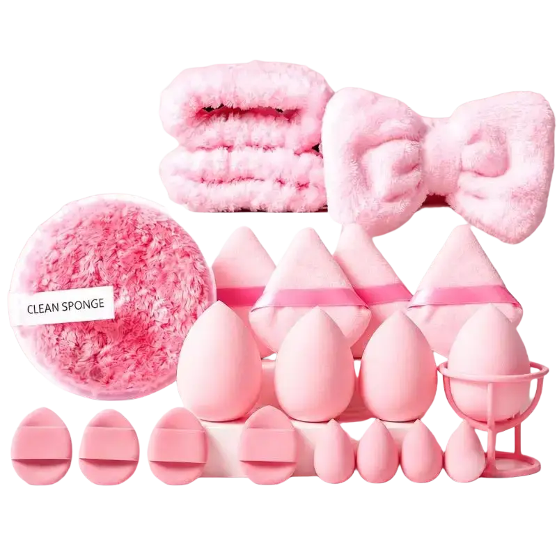 Pink fluffy makeup sponges and applicators on pink surface for natural makeup application and flawless finish makeup tool set