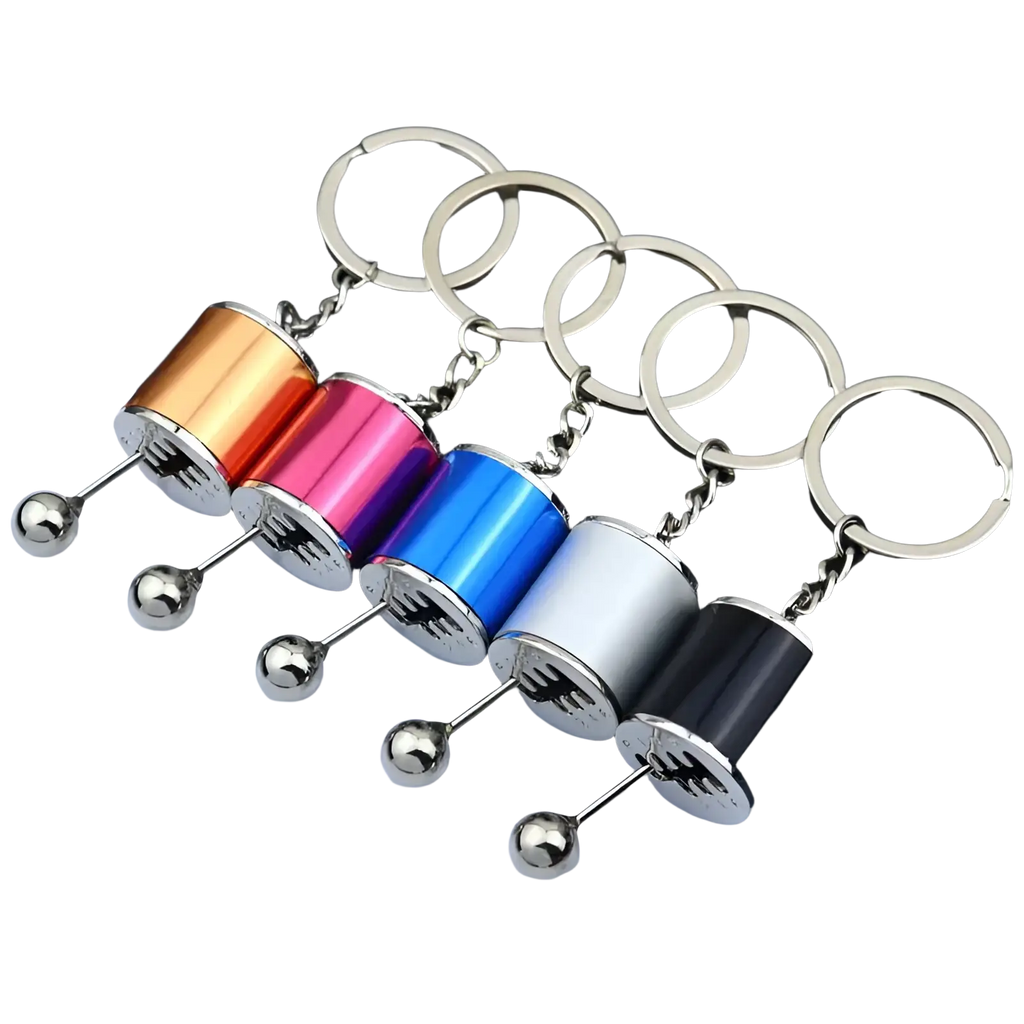 A set of five colorful metallic manual gear shift car keychains with silver spherical ends and chrome chains