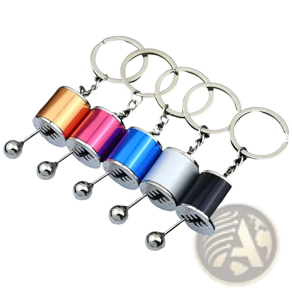 A set of five colorful metallic manual gear shift car keychains with silver spherical ends and chrome chains