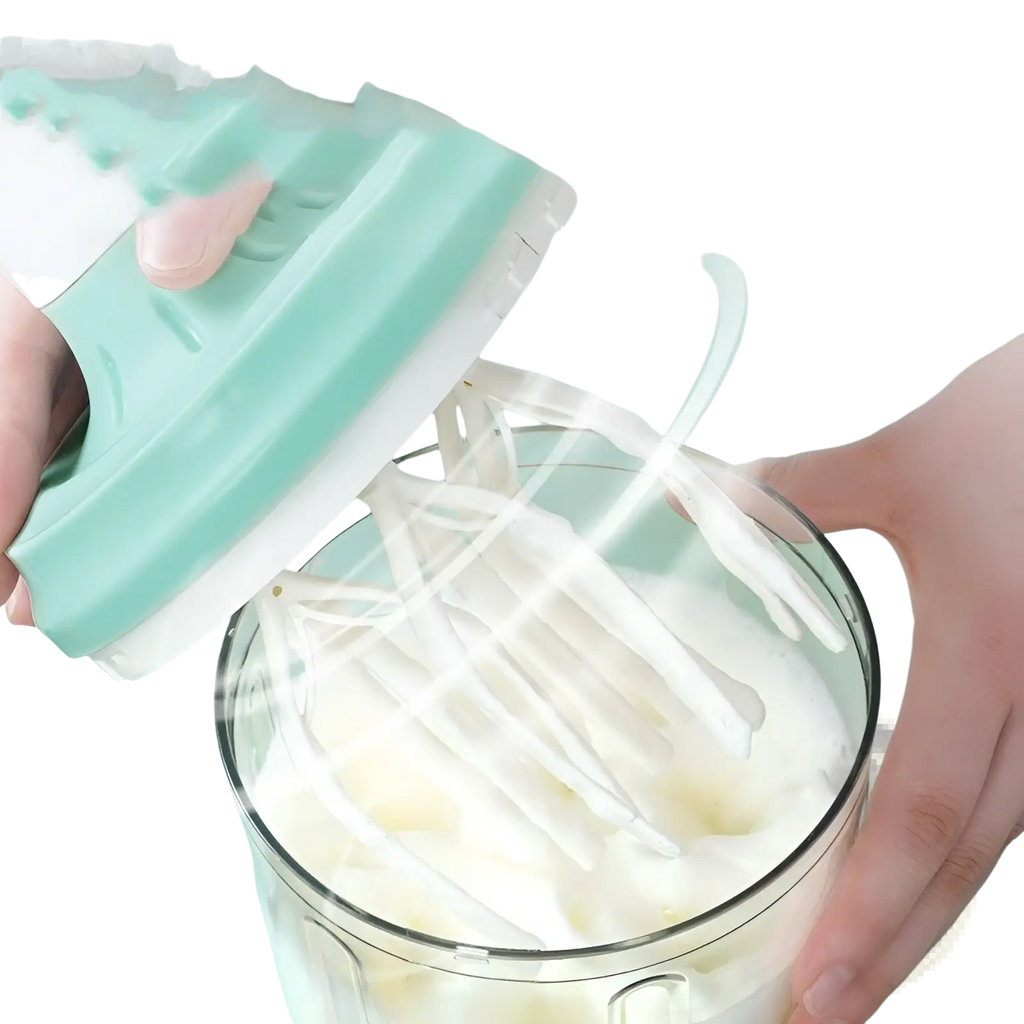A mint green and white handheld electric mixer with ergonomic design whipping cream in a glass bowl for food mixing
