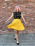 Vintage marigold yellow high waisted a-line skirt with flowing fabric and pockets for a stylish skater look