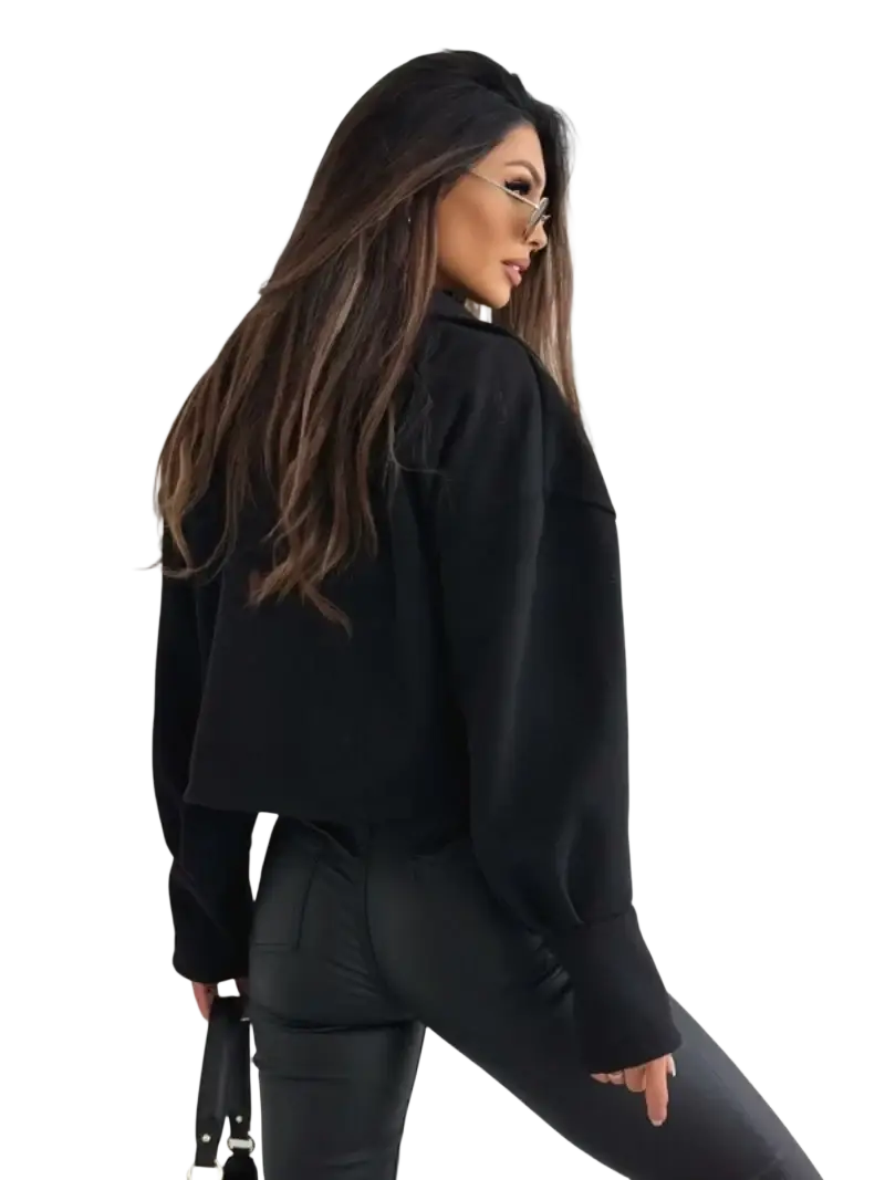 Black cropped long-sleeve blouse with relaxed fit and subtle texture shown as part of maroon cropped double breasted wool coat ensemble
