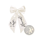 Just married car bow wedding decor with cream satin material and black cursive script on the ribbons