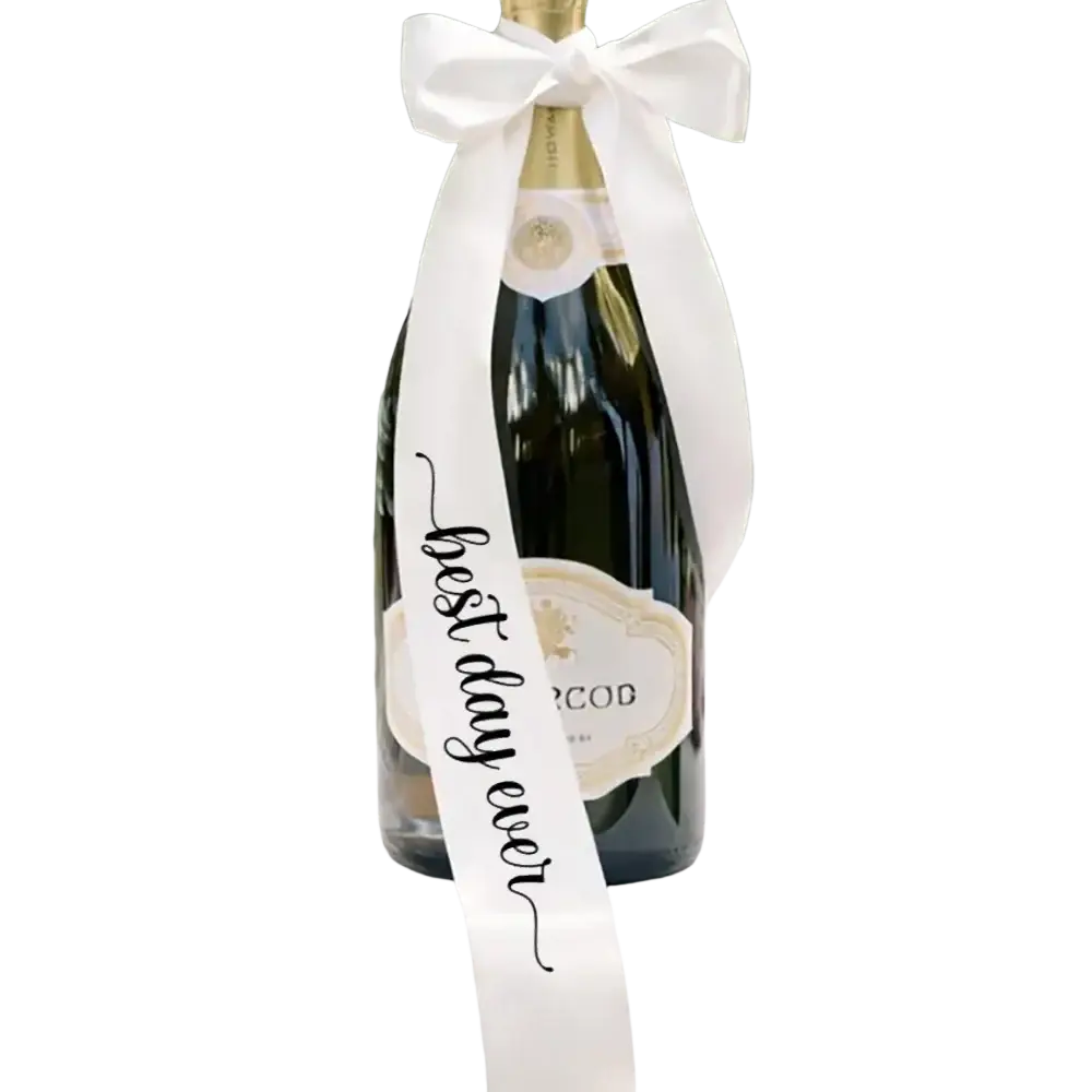 Just married wine bottle ribbon wedding decor featuring a dark green glass bottle with a white satin best day ever bow