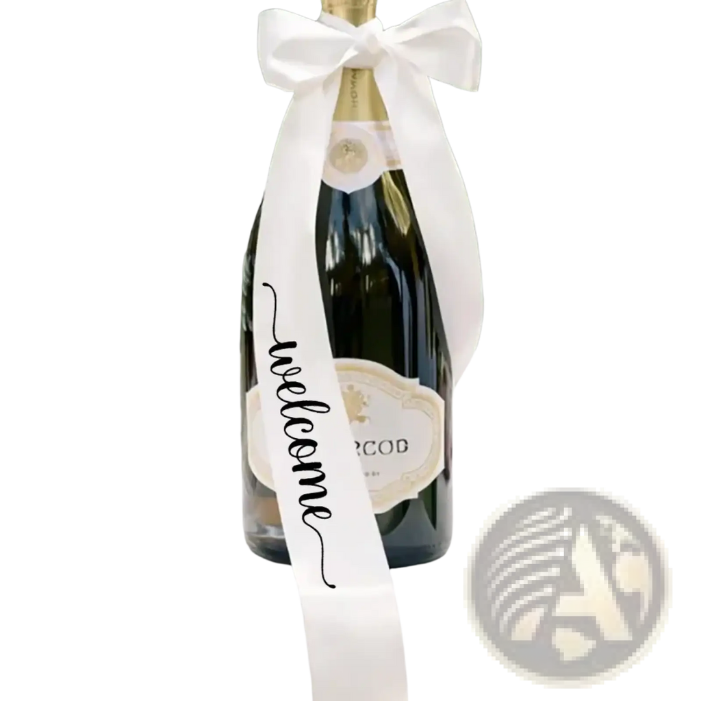 A dark green glass just married wine bottle decorated with a white satin welcome ribbon bow for wedding decor