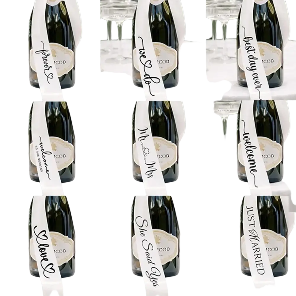 Just married wine bottle ribbon wedding decor featuring white satin with black cursive script and heart motifs on dark green bottles