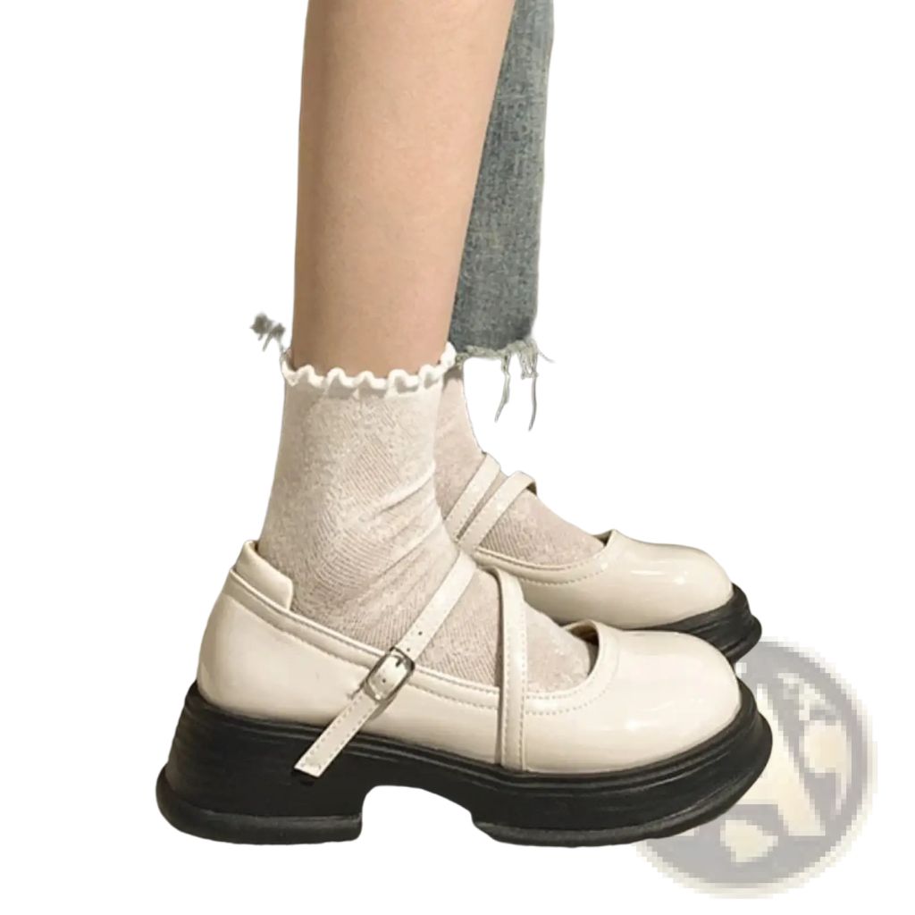 Cream-colored patent leather mary jane chunky platform shoes with thick black sole and adjustable strap