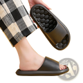 Black rubber slide sandal featuring a honeycomb textured sole designed for massage and comfort