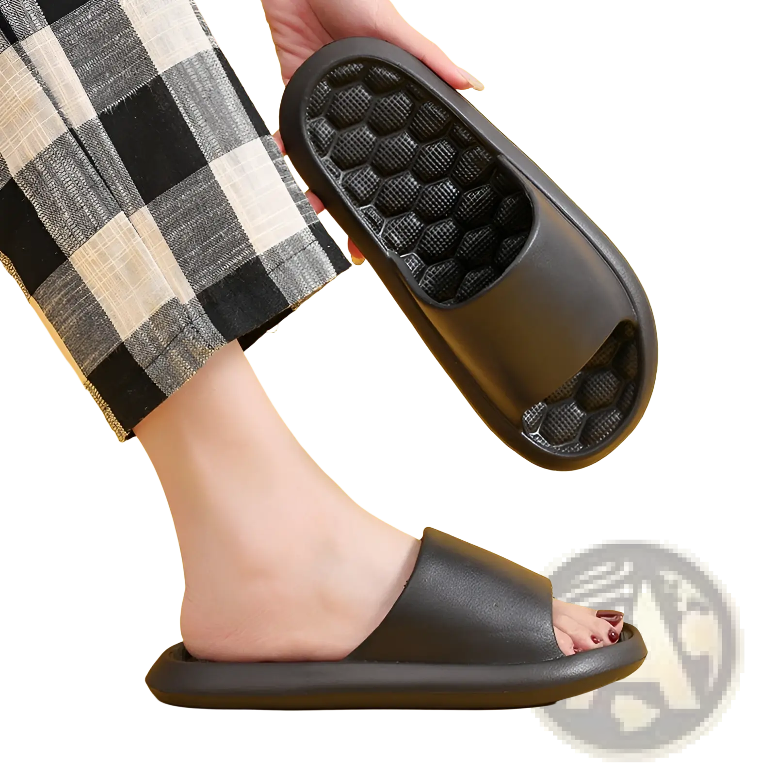 Black rubber slide sandal featuring a honeycomb textured sole designed for massage and comfort