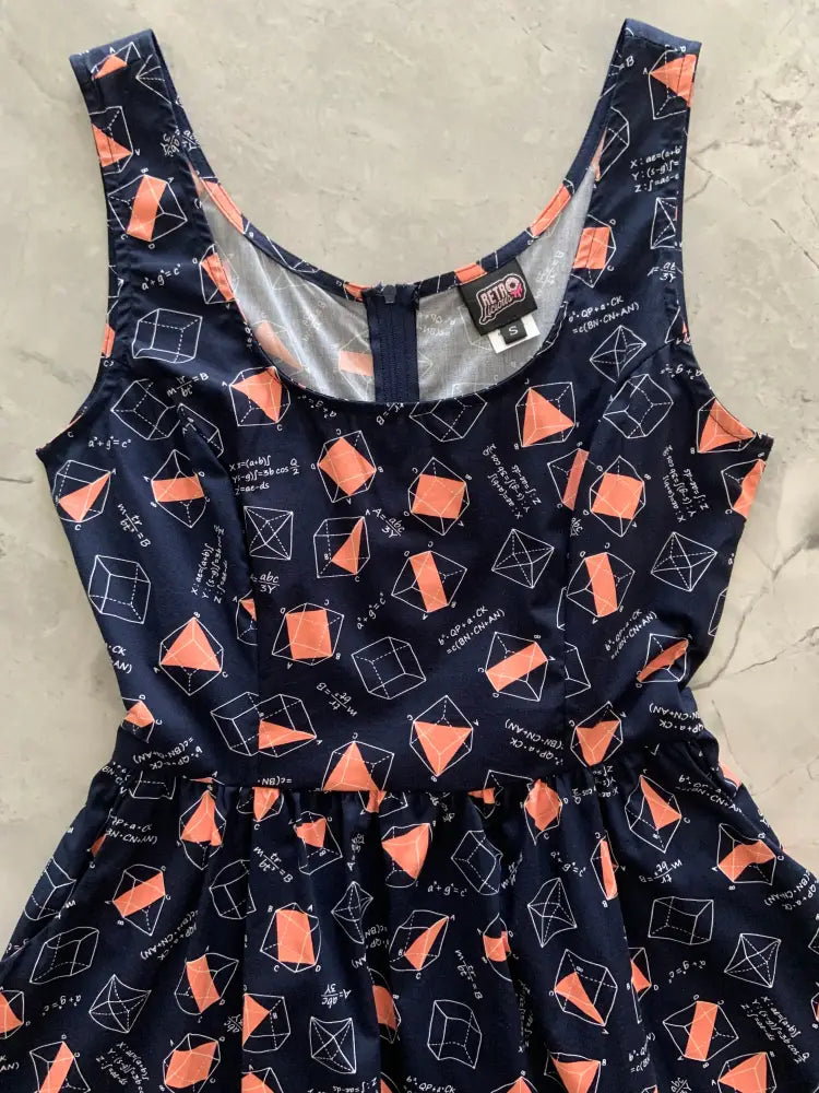 Navy math print fit and flare cotton dress with pockets featuring orange geometric shapes and white equations
