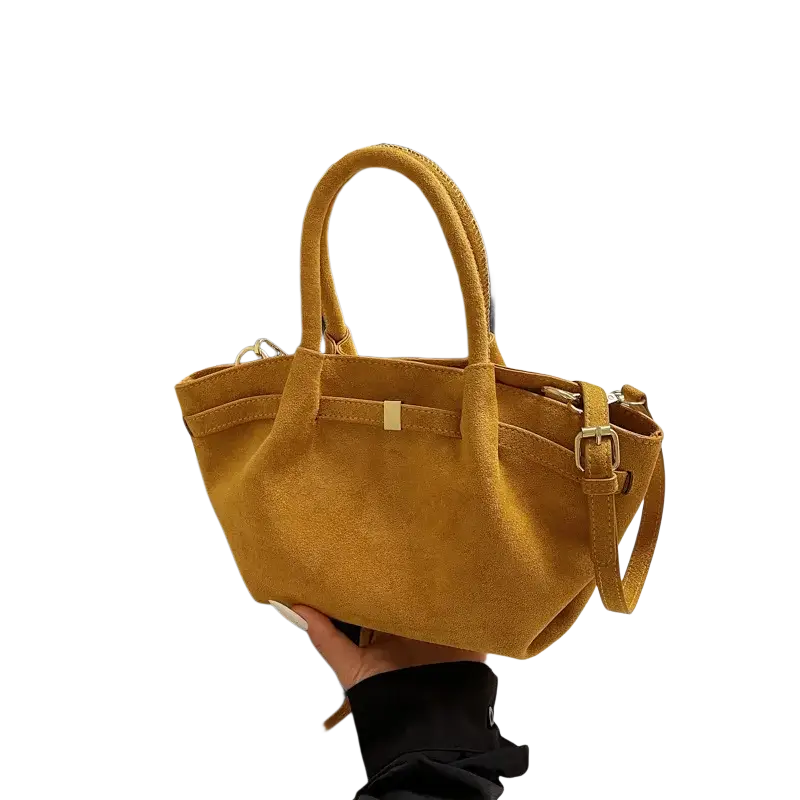 Mustard-yellow suede mini tote bag with gold-tone hardware and detachable shoulder strap for versatile crossbody wear