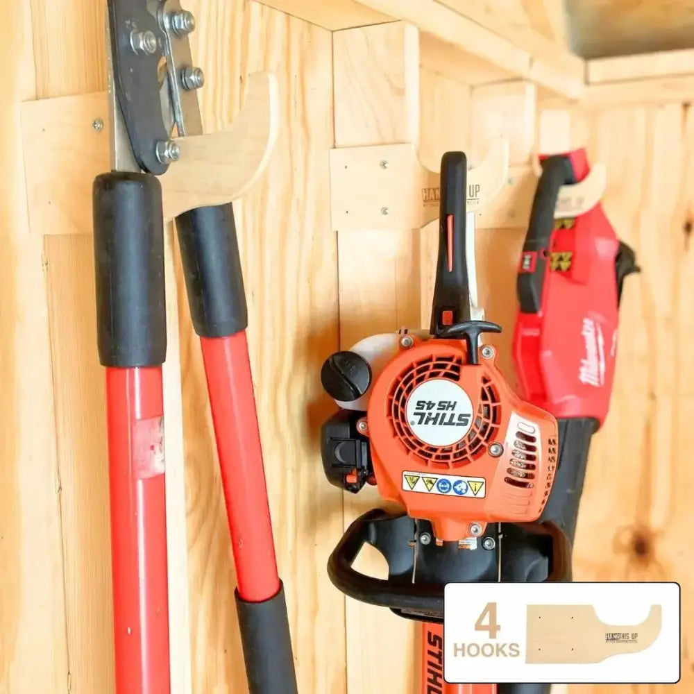 Orange and black stihl hs 45 hedge trimmer mounted on wooden rack in max birch plywood stud mounted shed organization kit