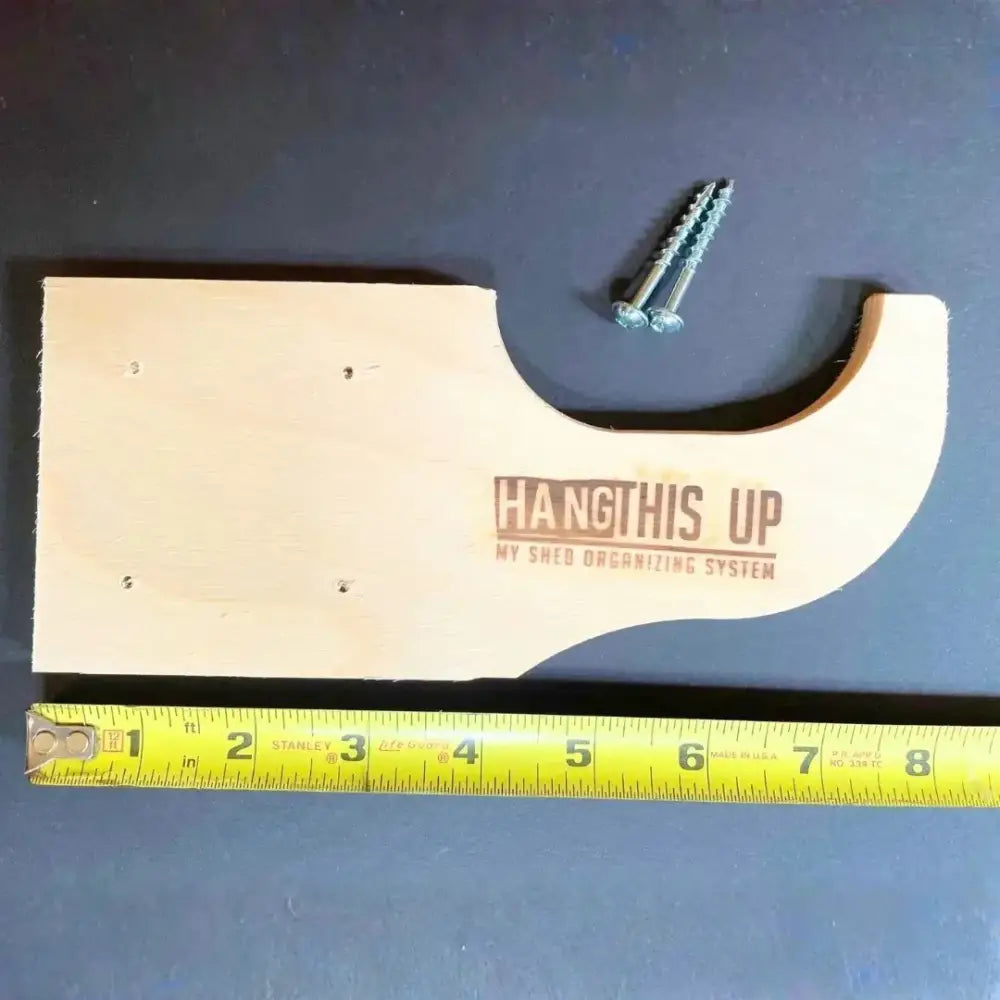 Light-colored wooden shed organizer with curved cutout and printed text for max birch plywood stud mounted shed kit