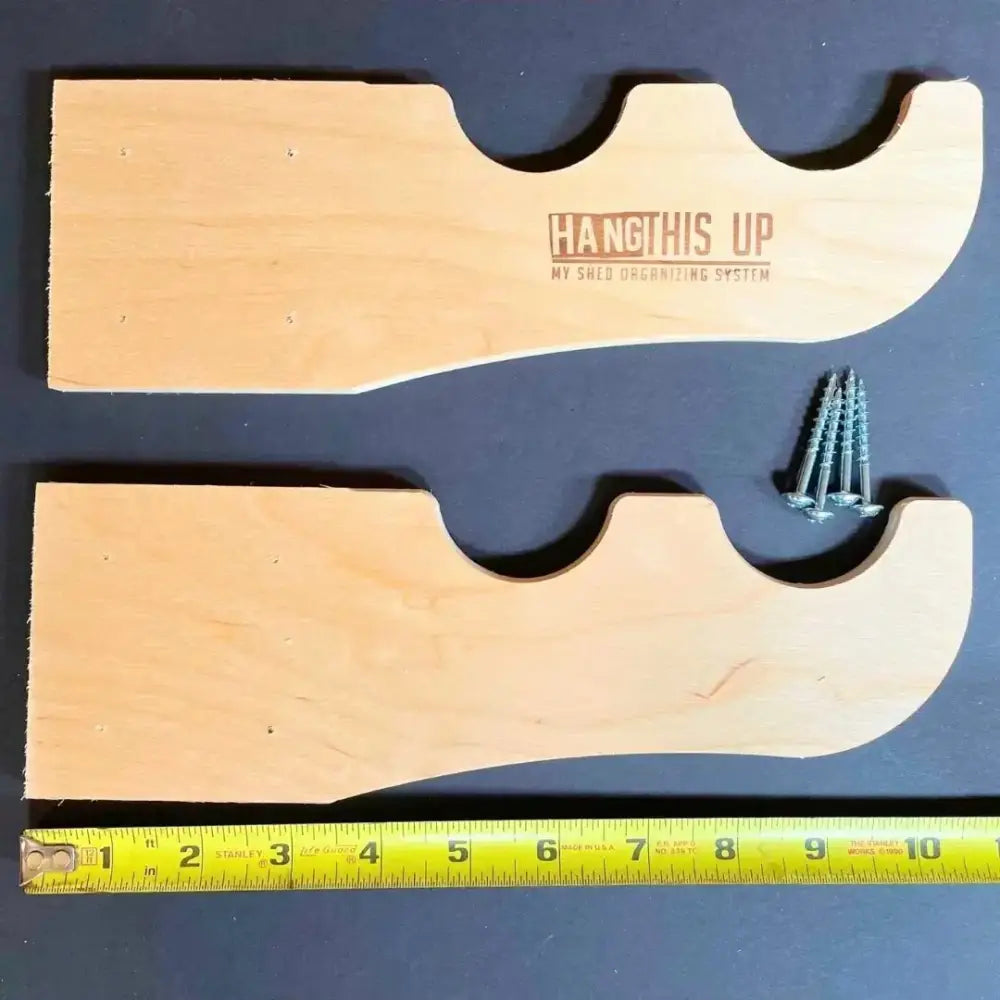 Light-colored wooden shelf brackets with wave cutouts and engraved text for max birch plywood shed organization kit