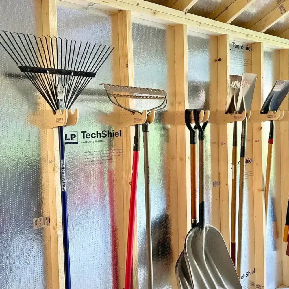 Wooden max birch plywood stud mounted shed organization kit holding various garden tools on a wall-mounted rack