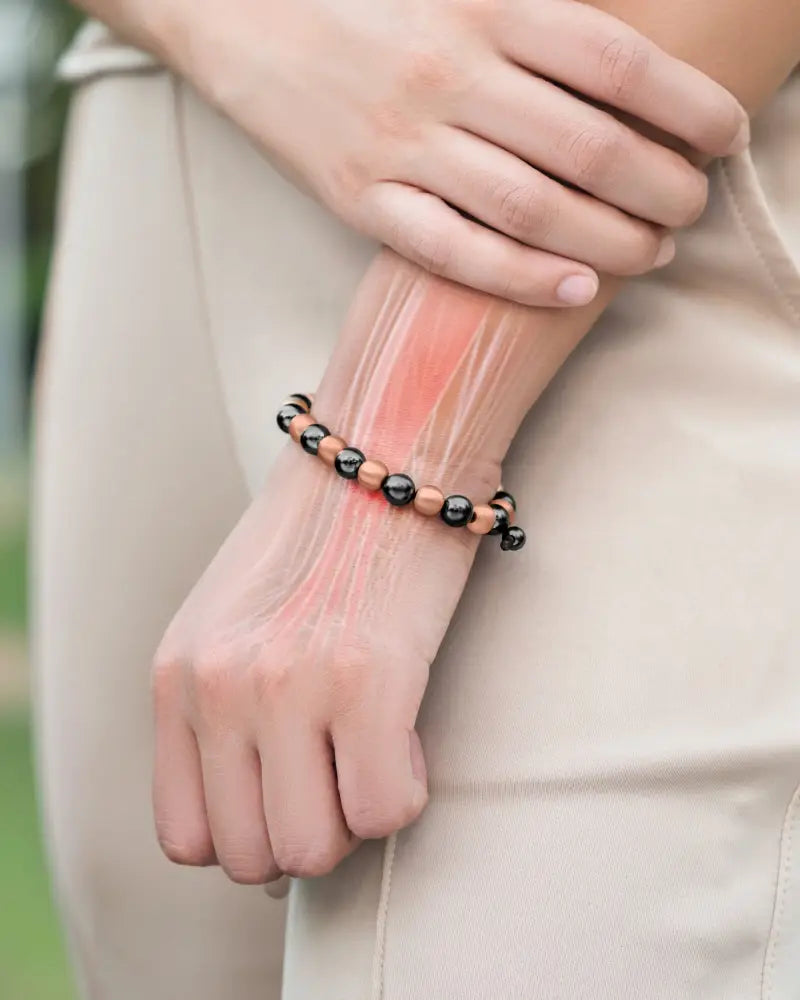 A max strength magnetic hematite and copper beaded bracelet with alternating black and rose gold beads worn on a wrist