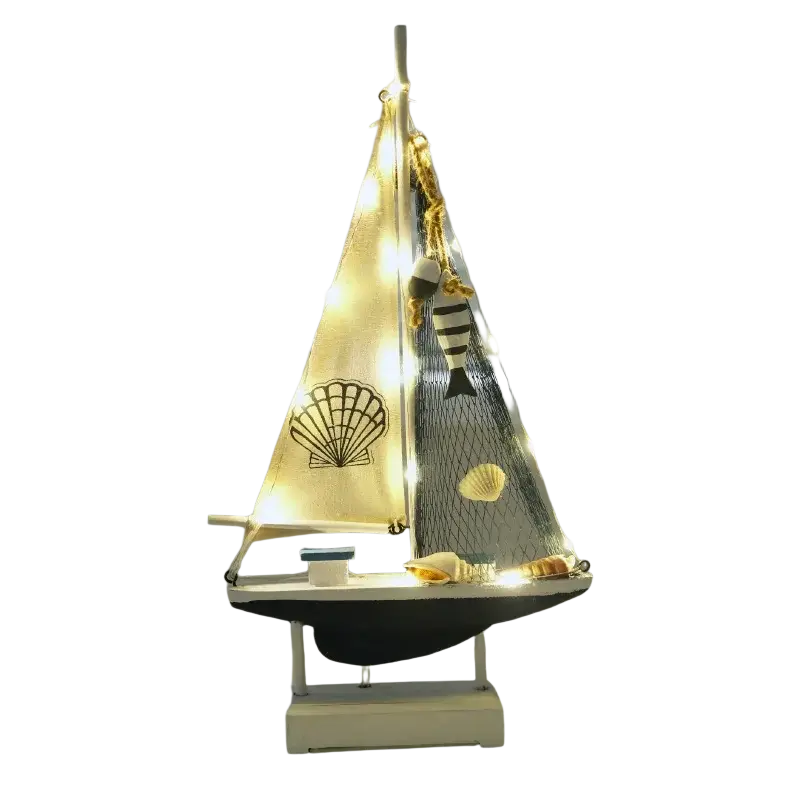 Mediterranean style wooden led sailing boat home decor with cream fabric sail and striped fish ornament hanging from mast