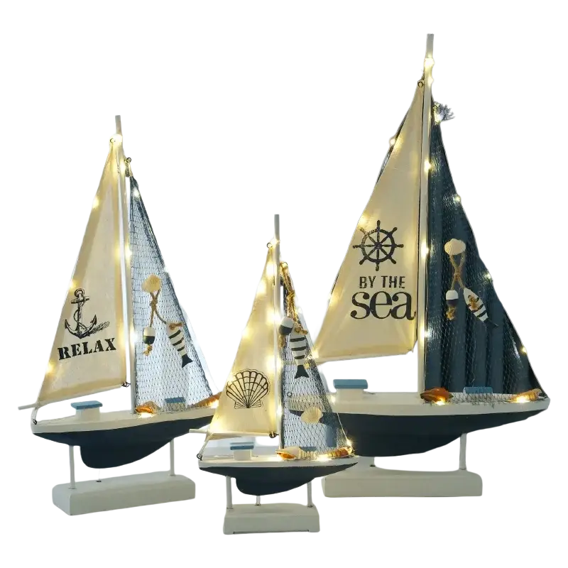 Mediterranean style wooden led sailing boat home decor with cream and navy sails featuring nautical motifs and lights