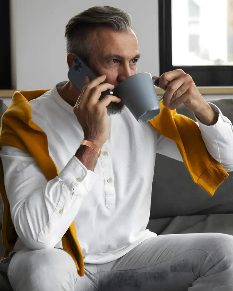 Gray ceramic mug with smooth matte finish shown alongside mega strength magnetic copper therapy cuff bracelet