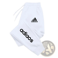 Men adidas sweatpants in white featuring black logo branding on the thigh and leg for athletic jogging use